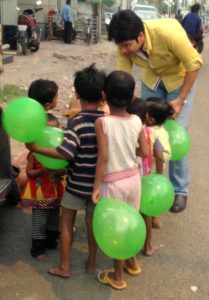 Vipul Gupta, Director Finance,  distributing chocolates to children